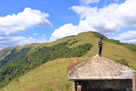 December 27 2022 - Kannur, Kerala in India: People enjoy hiking at the southern tip of the mighty western ghats, Paithalmalaのeditorial素材
