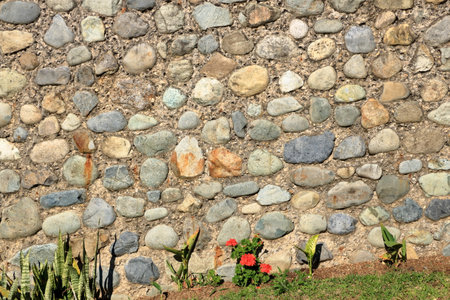 an old yellowed natural stone wallの写真素材