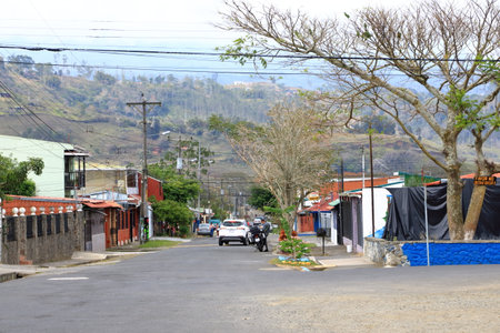 March 3 2023 - Orosi in Costa Rica: Street view of a small town with people walking on the narrow streets in the local neighbourhood living their everyday lifeのeditorial素材