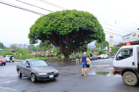 March 7 2023 - La Fortuna in Costa Rica: Main street with cars, shops and pedestriansのeditorial素材
