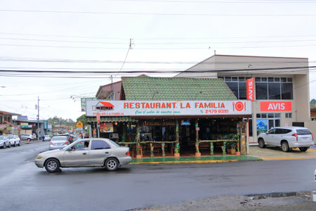 March 7 2023 - La Fortuna in Costa Rica: Main street with cars, shops and pedestriansのeditorial素材