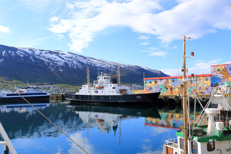 May 28 2022 - Tromso in Norway: picturesque harbor at Tromso in far northern Norway in summer, with colorful boatsのeditorial素材
