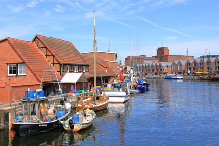 May 05 2023 - Wismar, Mecklenburg-Vorpommern in Germany: Scenic summer outdoor view of the Old Port pier town architecture with ships and boatsのeditorial素材