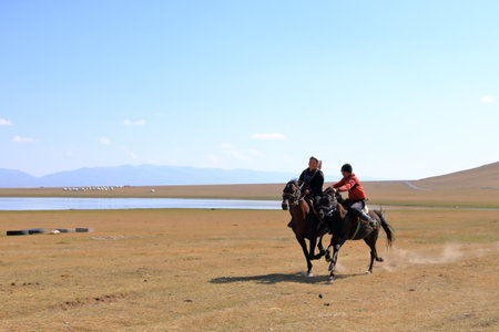 August 24 2023 - Song kol Lake in Kyrgyzstan: Performance of kyz kuuma (girl chasing), equestrian traditional sportのeditorial素材