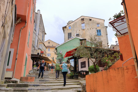 May 27 2023 - Corte, Island of Corsica in France: Tourists walking in historic downtown of Corte city in Corsica surrounded by mountainsのeditorial素材