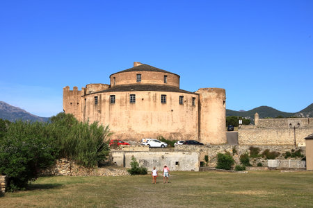 June 02 2023 - Saint-Florent, Corsica in France: people in the inner city with coloured housesのeditorial素材