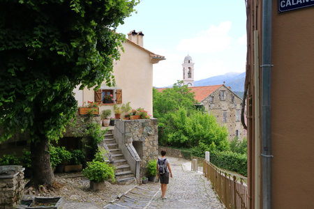 May 27 2023 - Corte, Island of Corsica in France: Tourists walking in historic downtown of Corte city in Corsica surrounded by mountainsのeditorial素材