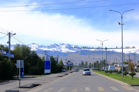August 29 2023 - Karakol in Kyrgyzstan: View over the street with cars and shops in the small cityのeditorial素材