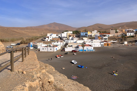 November 20 2023 - Ajuy, Fuerteventura in Spain: Ajuy village with colourful houses and fishing boats on the black sand of the beachのeditorial素材