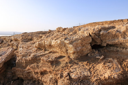 Ecological catastrophe of the Dead Sea. Erosion and salt formations on the surface of the earth in Jordanの写真素材