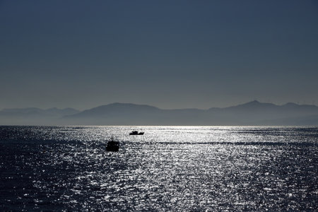 a small fishing boat in the Strait of Gibraltar between Tarifa and Tangierの写真素材