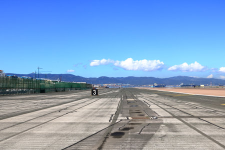 empty runway at Gibraltar Airport with view to the seaの写真素材