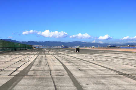 empty runway at Gibraltar Airport with view to the seaの写真素材