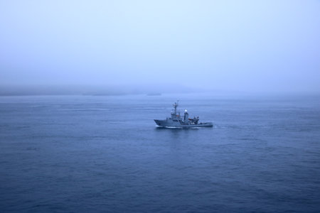 a ship in the fog approaches the Faroe Islands in Denmarkの写真素材