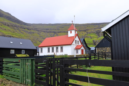 Tjornuvik, Streymoy, Faroe Islands, Denmark, a village surrounded by dramatic mountains and oceanの写真素材