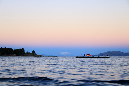 San Pablo de Tiquina in Bolivia - Mai 30 2025: busses and cars crossing the Strait of Tiquina on the Titicaca lakeのeditorial素材
