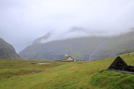 Saksun, Streymoy, Faroe Islands in Denmark - August 26 2025: people visit the Saksun Heritage Farm and churchのeditorial素材