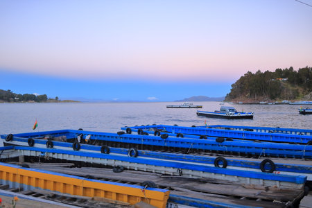 San Pablo de Tiquina in Bolivia - Mai 30 2025: busses and cars crossing the Strait of Tiquina on the Titicaca lakeのeditorial素材