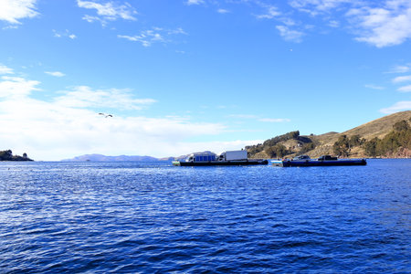 San Pablo de Tiquina in Bolivia - Mai 30 2025: busses and cars crossing the Strait of Tiquina on the Titicaca lakeのeditorial素材