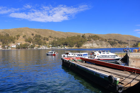 San Pablo de Tiquina in Bolivia - Mai 30 2025: busses and cars crossing the Strait of Tiquina on the Titicaca lakeのeditorial素材
