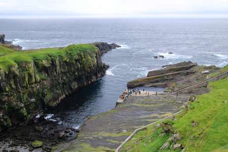 Mykines, Faroe Islands in Denmark - August 25 2025: View of Mykines Harbor with tourists visiting the island to watch puffinsのeditorial素材