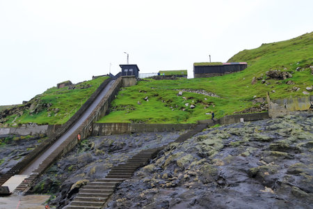 Mykines, Faroe Islands in Denmark - August 25 2025: View of Mykines Harbor with tourists visiting the island to watch puffinsのeditorial素材