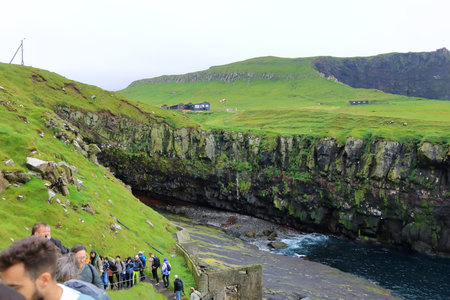 Mykines, Faroe Islands in Denmark - August 25 2025: View of Mykines Harbor with tourists visiting the island to watch puffinsのeditorial素材