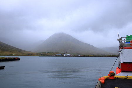 Siglufjordur in Iceland - August 30 2025: at the harbor of the beautiful village on a cloudy dayのeditorial素材