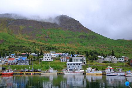 Siglufjordur in Iceland - August 30 2025: at the harbor of the beautiful village on a cloudy dayのeditorial素材