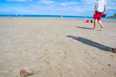 people walking on the beach, going swimmingの写真素材