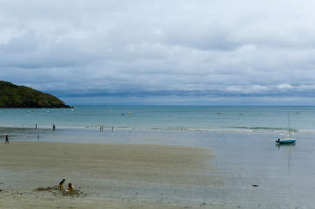 a boat lying on the beach at low tideの写真素材
