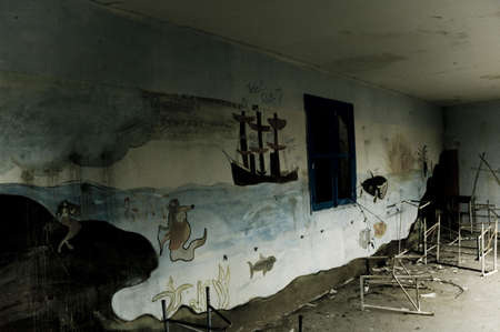 a painting on the wall of a vandalised buildingの写真素材