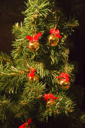 a few bells hanging from a christmas treeの写真素材