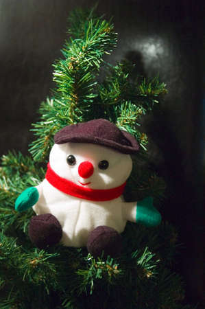 a santa claus puppet in a christmas treeの写真素材