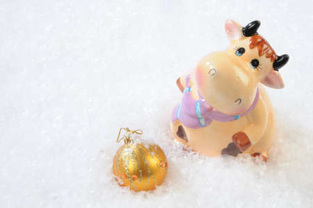 bull-calf-souvenir and fir-tree toy on to snowの写真素材