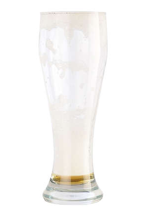 remnants of the foam and the beer in the high glassの写真素材