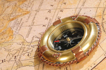 old-fashioned compass on a background an old mapの写真素材