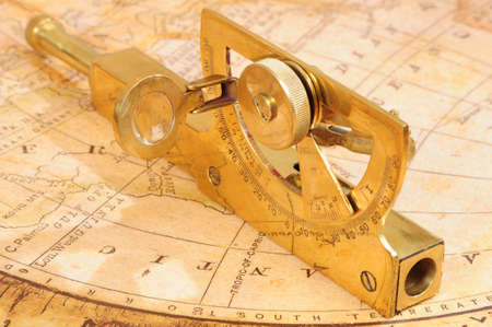 old-fashioned navigation device on a background an old map