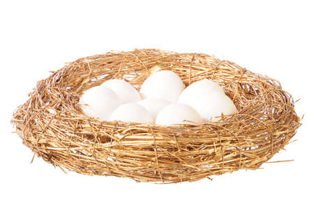 white eggs in golden nestの写真素材