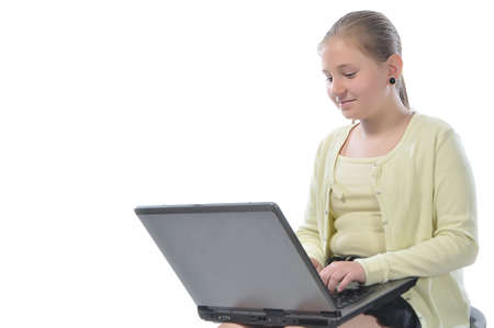 girl 11 years sits with a laptop on knees
