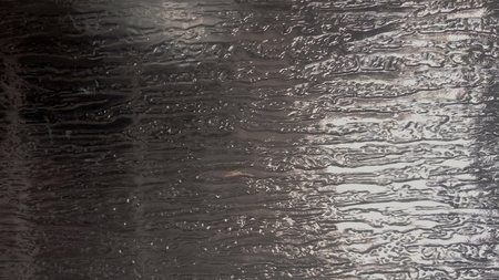 abstract background of water drops on a wet glass surface closeup