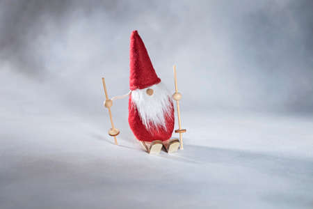 Christmas gnome or santa claus on skisの写真素材