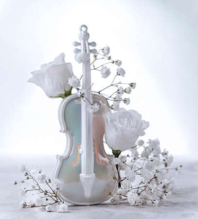delicate composition with artificial violin and white flower buds