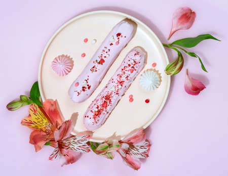 Delicate custard cakes on a pink backgroundの写真素材