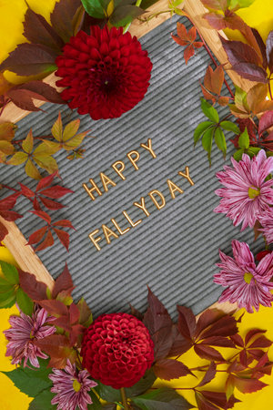 letter board with quote Happy Fallyday in autumn leaves and flowers, autumn backgroundの写真素材