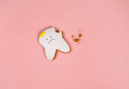 gingerbread in the shape of a tooth, background for the concept of pediatric dentistry and tooth fairyの写真素材