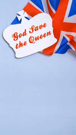 paper silhouette of the british royal crown on the background of the flag of the united kingdom of great britain and northern irelandの写真素材