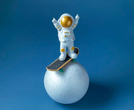 miniature astronaut figurine on a skateboard, International Day of Human Space Flight conceptの写真素材