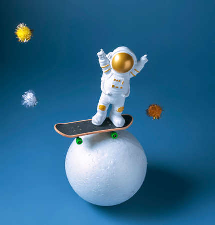 miniature astronaut figurine on a skateboard, International Day of Human Space Flight conceptの写真素材