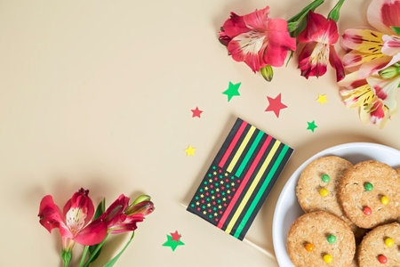 creative background for Juneteenth day with Black Liberation African American flags, tea cakes cookie and bright flowersの写真素材